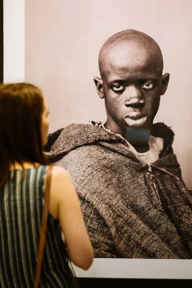 A photograph of a print of a photograph featuring a portrait of a Moroccan man looking out at the viewer