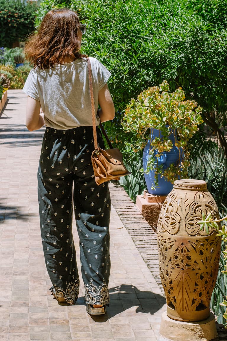 Sarah walking along a path in a garden