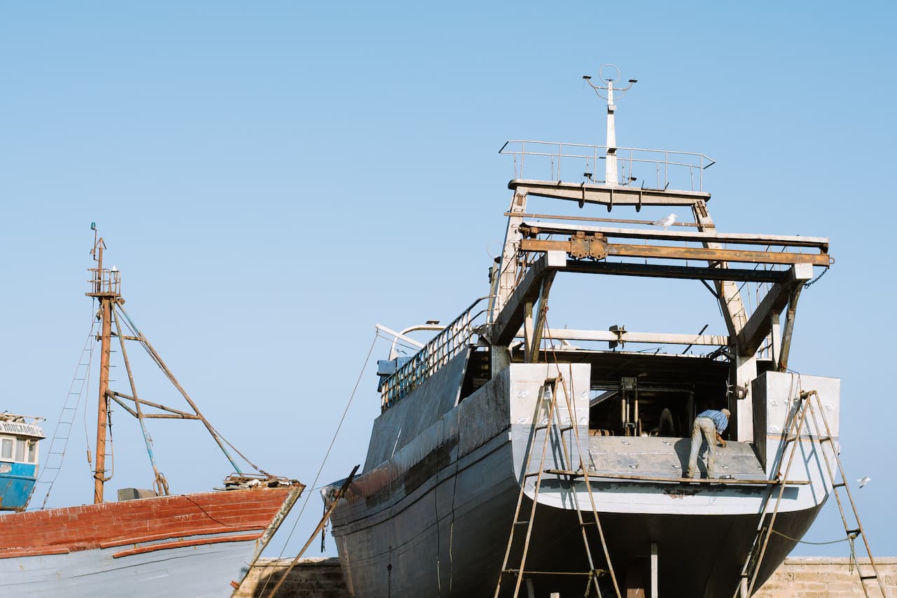 A man working on his boat in Essaouira