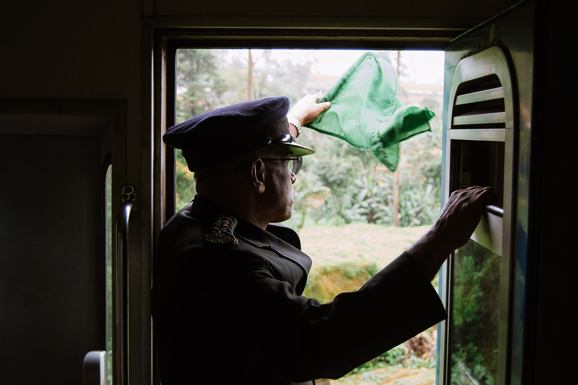 Train conductor waving a flag