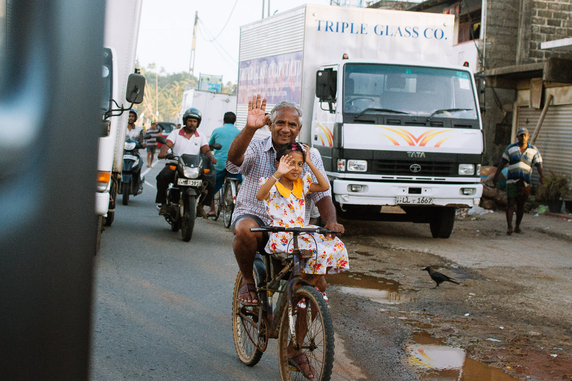 A Sri lankan man and a girl on a bike